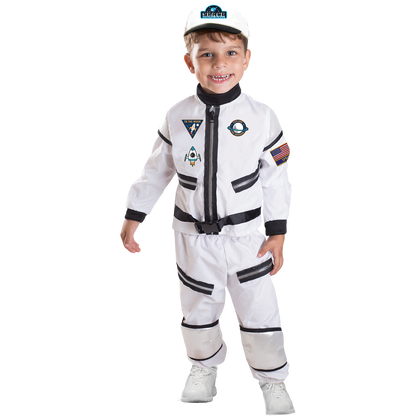 Model wearing Lola Stars toddler astronaut costume: white shirt with mission patches, striped white pants and white cap