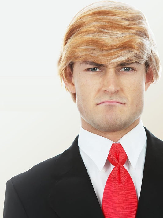 Model wearing the Allaura swept-over blonde costume wig with a dark suit and red tie